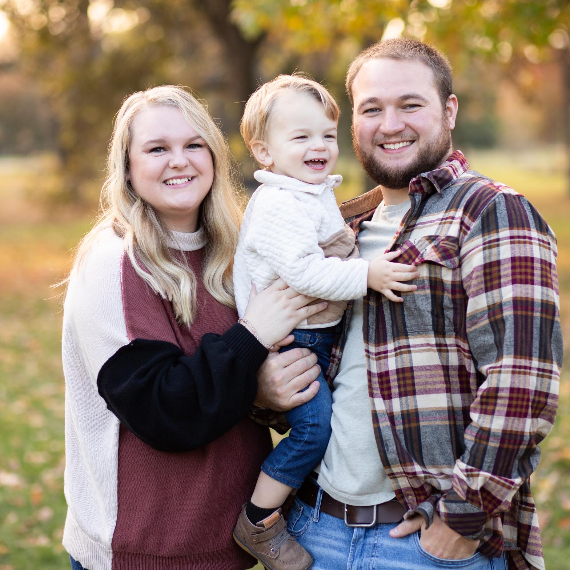 Image of bridesmaid Brooke her husband Colton, whom is also a groomsmen, and their child Camden.